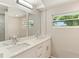 Bright bathroom featuring a double sink vanity with modern fixtures and quartz countertops at 2005 Sunny Ln, New Smyrna Beach, FL 32168