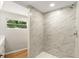Modern bathroom featuring a tiled walk-in shower and wood-look laminate flooring at 2005 Sunny Ln, New Smyrna Beach, FL 32168