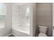 Bathroom featuring a tub with marble tile and a window at 2005 Sunny Ln, New Smyrna Beach, FL 32168