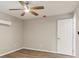 Neutral-toned bedroom offers wood floors, ceiling fan and an air conditioning unit at 2005 Sunny Ln, New Smyrna Beach, FL 32168