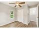 Neutral bedroom featuring a ceiling fan, closet and doorway to another room at 2005 Sunny Ln, New Smyrna Beach, FL 32168
