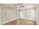 Bright bedroom features wood floors, a ceiling fan and white closet doors, creating a cozy space at 2005 Sunny Ln, New Smyrna Beach, FL 32168