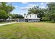 Charming two-story home with well-maintained lawn and gray and white exterior at 2005 Sunny Ln, New Smyrna Beach, FL 32168