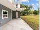 Exterior of a home with a covered entryway and a freshly sealed concrete walkway at 2005 Sunny Ln, New Smyrna Beach, FL 32168