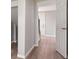 Hallway with light-colored walls and wood-look floors leading to a door at 2005 Sunny Ln, New Smyrna Beach, FL 32168