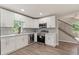 Renovated kitchen featuring stainless steel appliances, white cabinets, and stylish backsplash at 2005 Sunny Ln, New Smyrna Beach, FL 32168
