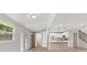 Bright living space with open access to an updated kitchen and a staircase with modern railing at 2005 Sunny Ln, New Smyrna Beach, FL 32168