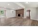 Living room featuring refinished fireplace, lots of natural light and new floors throughout at 2005 Sunny Ln, New Smyrna Beach, FL 32168