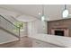 Bright living room featuring a modern fireplace, staircase, and kitchen island at 2005 Sunny Ln, New Smyrna Beach, FL 32168
