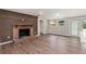 Living room with refinished brick fireplace, natural light, and modern luxury vinyl flooring at 2005 Sunny Ln, New Smyrna Beach, FL 32168