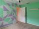 Bedroom with unique geometric wall design and ceiling fan at 2029 Willow Oak Dr, Edgewater, FL 32141