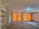 Spacious garage with two large doors and ample storage shelves at 2029 Willow Oak Dr, Edgewater, FL 32141