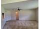 Open living room featuring a ceiling fan and neutral carpeting and paint at 2029 Willow Oak Dr, Edgewater, FL 32141