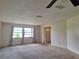 Living room featuring neutral carpet, large windows, and access to the foyer at 2029 Willow Oak Dr, Edgewater, FL 32141