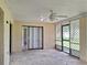 An empty screened in porch features a ceiling fan and access to the backyard at 2029 Willow Oak Dr, Edgewater, FL 32141