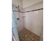Shower with white tiling, decorative accent strip, and updated shower head at 2029 Willow Oak Dr, Edgewater, FL 32141