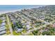 Bright aerial view of a beach neighborhood with tree-lined streets and beach access at 206 Kirkland Rd, New Smyrna Beach, FL 32169