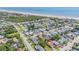 Aerial view showcases proximity to the beach and community in a lush, coastal neighborhood on a sunny day at 206 Kirkland Rd, New Smyrna Beach, FL 32169