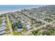An aerial view of a coastal neighborhood with mature trees, single-Gathering homes and the beach in the background at 206 Kirkland Rd, New Smyrna Beach, FL 32169