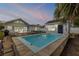 Inviting backyard featuring a pool, patio, spa, outdoor seating, and additional building at 206 Kirkland Rd, New Smyrna Beach, FL 32169