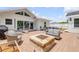Beautiful backyard with a fire pit, dining, and lounge furniture at 206 Kirkland Rd, New Smyrna Beach, FL 32169