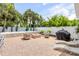 Tropical backyard features a pool, fire pit, and outdoor kitchen, perfect for entertaining at 206 Kirkland Rd, New Smyrna Beach, FL 32169