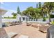 Luxurious backyard features a pool, fire pit, summer kitchen, and dining area at 206 Kirkland Rd, New Smyrna Beach, FL 32169