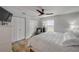 Bedroom featuring queen bed with white comforter, closet, tv, and seating area at 206 Kirkland Rd, New Smyrna Beach, FL 32169