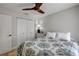 Bedroom featuring queen bed with patterned comforter, ceiling fan, and closet at 206 Kirkland Rd, New Smyrna Beach, FL 32169
