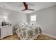 Bedroom featuring queen bed with patterned comforter, ceiling fan, and white nightstand at 206 Kirkland Rd, New Smyrna Beach, FL 32169