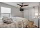 Bedroom featuring queen bed with patterned comforter, ceiling fan, and closet at 206 Kirkland Rd, New Smyrna Beach, FL 32169