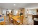 Open-concept dining room with wooden furniture, tile floors, and access to living areas at 206 Kirkland Rd, New Smyrna Beach, FL 32169