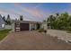 Charming single-story home featuring a modern garage door, brick driveway, and low maintenance landscaping at 206 Kirkland Rd, New Smyrna Beach, FL 32169