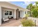 Inviting front porch with stylish seating and a dark-stained front door, perfect for relaxing at 206 Kirkland Rd, New Smyrna Beach, FL 32169