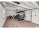Spacious garage featuring a brick floor and ample storage space, with a golf cart at 206 Kirkland Rd, New Smyrna Beach, FL 32169
