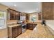 Bright kitchen featuring stainless steel appliances, granite countertops, dark wood cabinets, and natural light at 206 Kirkland Rd, New Smyrna Beach, FL 32169