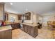 Spacious kitchen with granite countertops, stainless steel appliances, tile flooring, and adjacent dining area at 206 Kirkland Rd, New Smyrna Beach, FL 32169