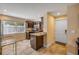 Bright kitchen with granite countertops, wood cabinetry, tile floor and natural light at 206 Kirkland Rd, New Smyrna Beach, FL 32169