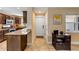 Kitchen featuring granite countertops, dark wood cabinets, and tile flooring at 206 Kirkland Rd, New Smyrna Beach, FL 32169
