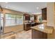 Well-lit kitchen features granite countertops, stainless steel appliances, tile flooring, and ample cabinet space at 206 Kirkland Rd, New Smyrna Beach, FL 32169