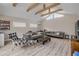 Open-concept living room with vaulted ceiling, wooden beams, modern furnishings and neutral color palette at 206 Kirkland Rd, New Smyrna Beach, FL 32169