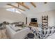 Bright living room featuring vaulted ceilings, exposed wooden beams, and stylish modern gray decor at 206 Kirkland Rd, New Smyrna Beach, FL 32169