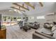 Living room with high ceilings, exposed beams, sliding door to brick patio and casual decor at 206 Kirkland Rd, New Smyrna Beach, FL 32169