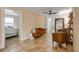Cozy living room featuring neutral paint, tile flooring, and doorways leading to bedrooms and other living spaces at 206 Kirkland Rd, New Smyrna Beach, FL 32169