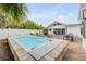 Relaxing pool with outdoor seating, dining area, and well-manicured landscaping at 206 Kirkland Rd, New Smyrna Beach, FL 32169
