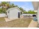 Pool house with an outdoor dining area, grill, and lush landscaping at 206 Kirkland Rd, New Smyrna Beach, FL 32169