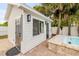 Stylish pool house featuring black door fixtures, and privacy fence at 206 Kirkland Rd, New Smyrna Beach, FL 32169