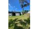 Backyard featuring green grass, an old tree, a wood fence, and room for outdoor activities at 2122 Orange Tree Dr, Edgewater, FL 32141