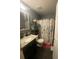 Bathroom with dark brown wood floors, vanity with granite countertop, and shower and toilet at 2122 Orange Tree Dr, Edgewater, FL 32141