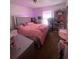 Bright bedroom with large decorative bed and pink decor with natural lighting at 2122 Orange Tree Dr, Edgewater, FL 32141